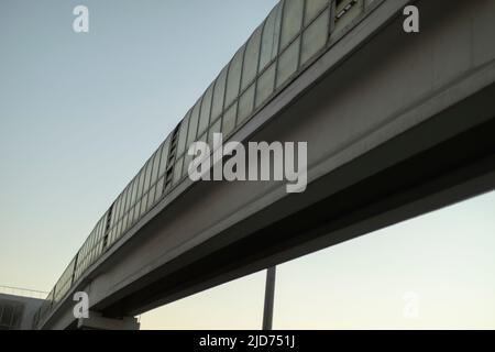 Long tunnel over road. Pedestrian crossing over highway. Details of urban infrastructure. Transport tunnel. Stock Photo