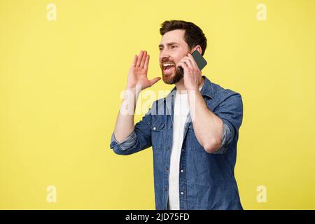 Happy man shouting loudly while talking on the phone and gesturing with his hands Stock Photo