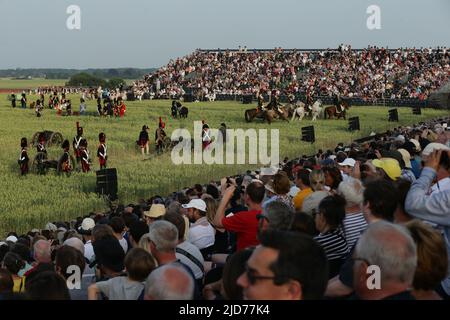 Waterloo, Belgium. 18th June, 2022. Spectators watch the re-enactment of the 1815 Battle of Waterloo in Waterloo, Belgium, June 18, 2022. About 2,000 re-enactors, more than 100 horses as well as over 20 canons participated in the re-enactment, showing the clash of June 18, 1815 between Napoleon and Wellington. The event marked the 207th anniversary of the Battle of Waterloo. Credit: Zheng Huansong/Xinhua/Alamy Live News Stock Photo