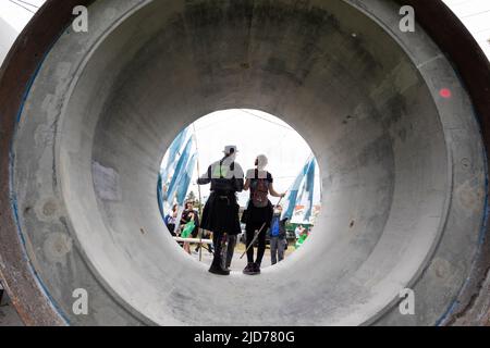 Seattle, Washington, USA. 18th June, 2022. Participants pose for a photo in an unfinished culvert at the Fremont Solstice Parade. The iconic, annual parade returned after a three-year hiatus due to the coronavirus pandemic. Credit: Paul Christian Gordon/Alamy Live News Stock Photo
