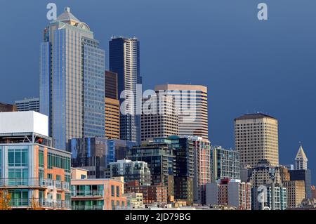 The sun peeks through a break in the clouds and lights the Seattle skyline Stock Photo