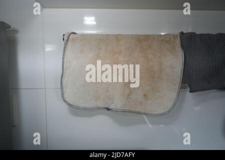 Dirty white towel hanging in a kitchen Stock Photo