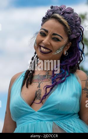 Coney Island, United States. 18th June, 2022. A woman wearing contacts and dressed as a mermaid poses for a photo. The Coney Island Mermaid Parade is the largest Art Parade in the United States. The parade celebrates the start of summer. Revelers dress as mermaids, fish and other sea creatures. Credit: SOPA Images Limited/Alamy Live News Stock Photo
