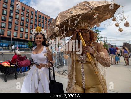 Coney Island, United States. 18th June, 2022. Women dressed as mermaids make their way to the start of the parade. The Coney Island Mermaid Parade is the largest Art Parade in the United States. The parade celebrates the start of summer. Revelers dress as mermaids, fish and other sea creatures. Credit: SOPA Images Limited/Alamy Live News Stock Photo