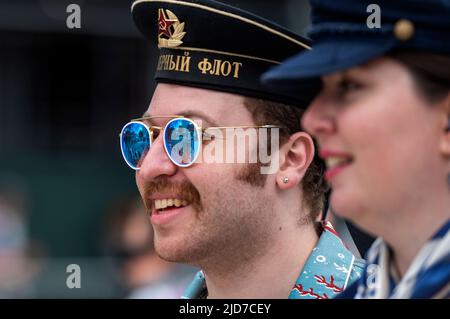 Coney Island, United States. 18th June, 2022. A man and woman look down the Mermaid Parade route. The Coney Island Mermaid Parade is the largest Art Parade in the United States. The parade celebrates the start of summer. Revelers dress as mermaids, fish and other sea creatures. Credit: SOPA Images Limited/Alamy Live News Stock Photo