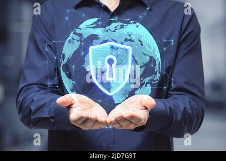 Global internet security concept with digital shield and keyhole inside virtual world globe projected from man hands Stock Photo