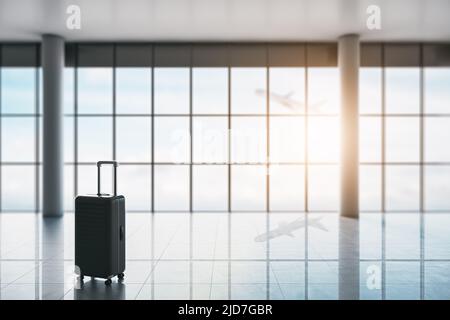 Business travel concept with hand suitcase in empty waiting area airport hall with glossy floor, columns and plane taking off behind huge window. 3D r Stock Photo