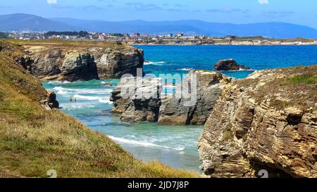 Aerial view of Las Catedrales beach with summer houses in the background along the seashore. Galicia Spain. Stock Photo