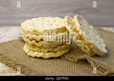 Cereal crisps with cereals close-up on a rough linen background with spices, pepper and chili, top view Stock Photo