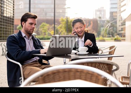 woman talking by phone over coffee with a partner Stock Photo