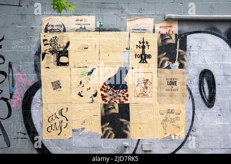 Street art paste-up posters in Alphabet City neighbourhood of New York City, United States of America Stock Photo