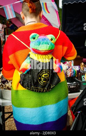 woman with plush frog toy on her back Stoke Gay Pride event in Hanley Park Saturday 18th June 2022 Stock Photo