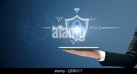 Security and internet safety concept with digital tablet on man hand and glowing digital lock symbol with fingerprint inside on abstract background Stock Photo