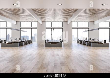 Side view on sunny open space office with rows of workspaces made from wooden tables and chairs on wooden floor, city view from huge windows and woode Stock Photo
