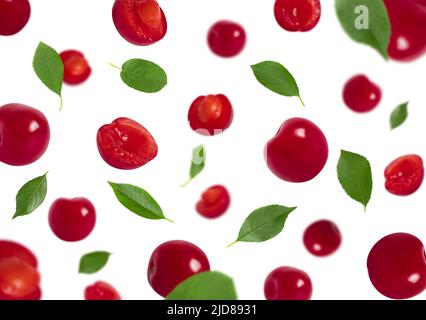 Set of falling cherries with green leaves isolated on a white background. Red berries flying in the air. Ripe juicy berries. Stock Photo