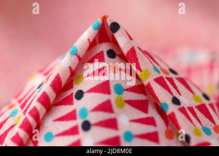 Multicolored bright cotton fabric with geometric shapes and figures Stock Photo