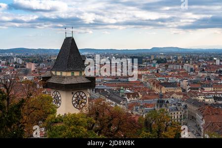 Aerial panorama view of Graz city old town from Schlossberg with Clock tower and city hall on autumn day,  with blue sky cloud and colorful trees, Gra Stock Photo