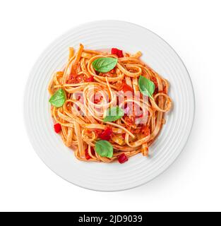 Pasta with tomatoes and basil is isolated on a white background. Stock Photo