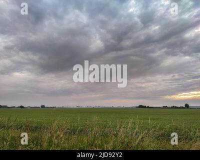 Clouds with precipitation fallstreaks which evaporate and barely reach the ground Stock Photo