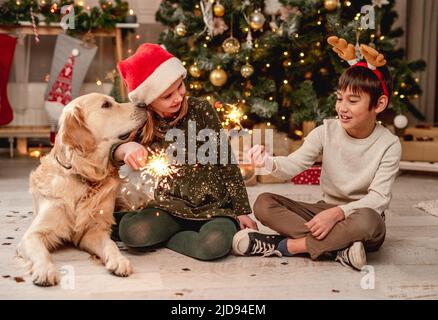 Little girl and boy holding sparklers Stock Photo