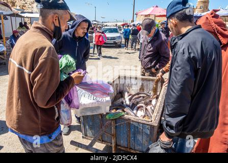 Sellers selling freshly caught eels seafood in the street popular with tourists and locals in Port of Essaouira, Morocco. Stock Photo