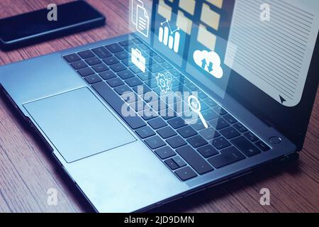 Laptop with virtual screen. Online documentation database and document management system concept. Stock Photo