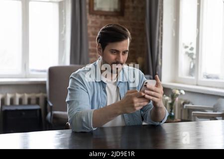 Millennial businessman using mobile business app on smartphone Stock Photo