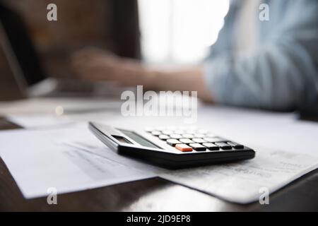 Heap of papers, bills and calculator on desk close up Stock Photo