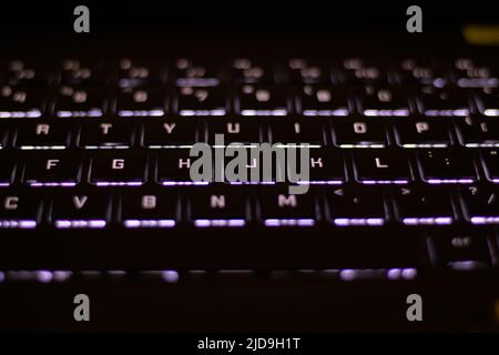 Backlit black computer keyboard at dark Stock Photo