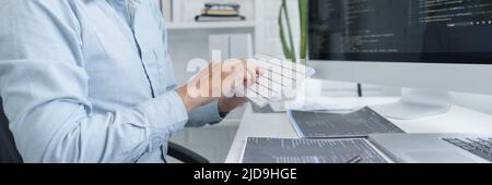 Software development concept, Male programmer using keyboard to typing data codes on computer. Stock Photo