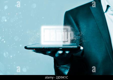 Battery icon on a virtual screen. businessman holds a tablet and charging icon. The concept of energy. Energy concept. Tablet with full battery on the screen Stock Photo