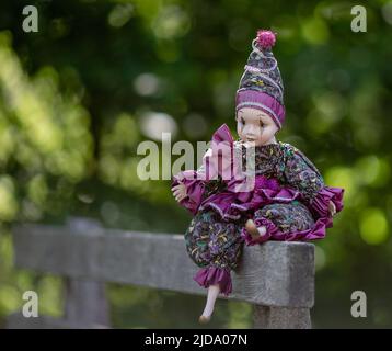 Amazing realistic vintage porcelain doll, toy, harlequin, selective focus Stock Photo