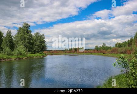 Summer landscape - flat river and blue sky with cirrus clouds. Stock Photo