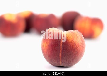 Fresh peaches on bright background. Selective focus. Stock Photo