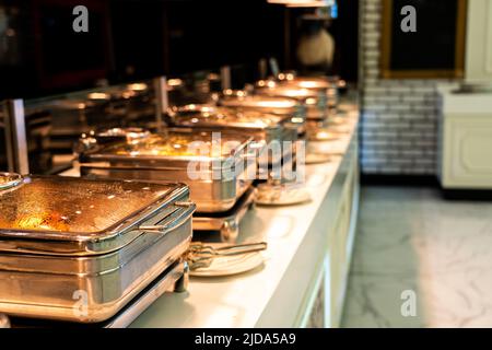 Many buffet heated trays ready for service in hotel restaurant Stock Photo