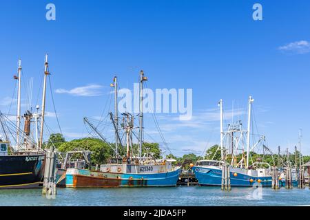 Three fishing vessels at the docks in Greenport, NY Stock Photo