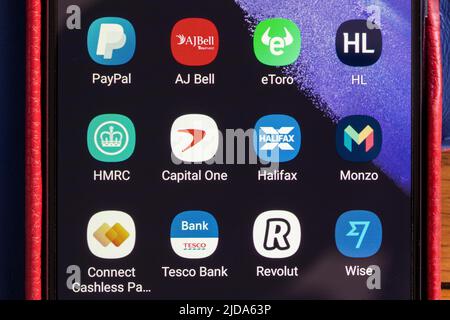 Closeup of banking, financial services, money transfer and stocks and share dealing and trading apps on a mobile phone screen in the UK Stock Photo
