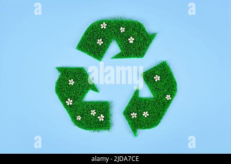 Recycling arrow symbol made from grass and flowers Stock Photo