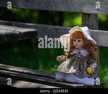 Amazing realistic vintage porcelain doll, toy with brown eyes, selective focus Stock Photo
