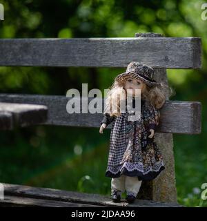 Amazing realistic vintage porcelain doll, toy with green eyes, selective focus Stock Photo