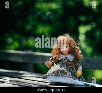 Amazing realistic vintage porcelain doll, toy with brown eyes, selective focus Stock Photo