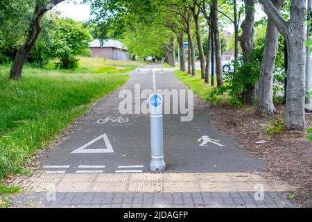 Shared path for pedestrians and bicycles, Wirral, England, UK. Isolated focus on the signpost with blurred background Stock Photo