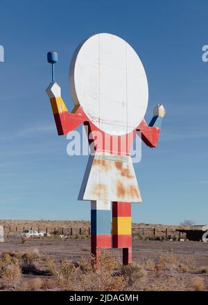 Old roadside attraction sign, a figure of a person with late for a head, cafe sign.