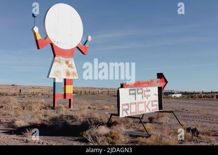 Old roadside attraction sign, a figure of a person with a plate for a head, cafe sign.