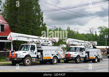 A boom truck of an electric utility company servicing an electric pole ...