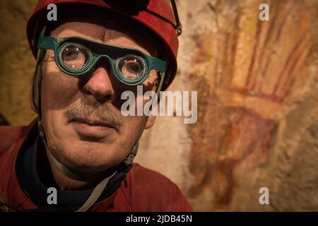 Portrait of a geologist using a strange device resembling spectacles, a 2-x binocular microscope allowing more precise collection of samples in the... Stock Photo