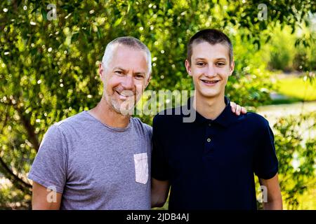 Outdoor portrait of a father with his teenage son; Edmonton, Alberta, Canada Stock Photo