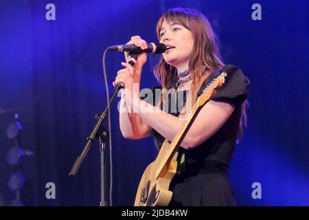 Newport, UK. 19th June, 2022. Rhian Teasdale, lead vocalist and rhythm guitarist with British indie rock band Wet Leg from the Isle of Wight UK performing live on stage at the Isle of Wight Festival. Credit: SOPA Images Limited/Alamy Live News Stock Photo