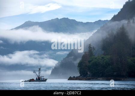 A salmon purse seiner and crew work the waters of Kachemak Bay for returning fish during the summer season in 2017. Stock Photo
