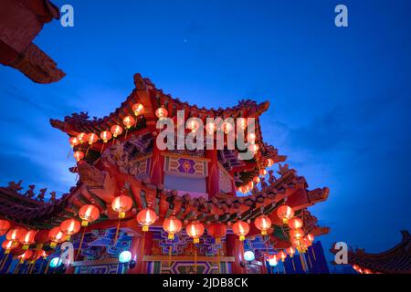 Kuala Lumpur, Malaysia - Feb 6th, 2022: Lighted red lanterns hanging on a pavilion at Thean Hou Temple, Kuala Lumpur Malaysia at dusk. Stock Photo